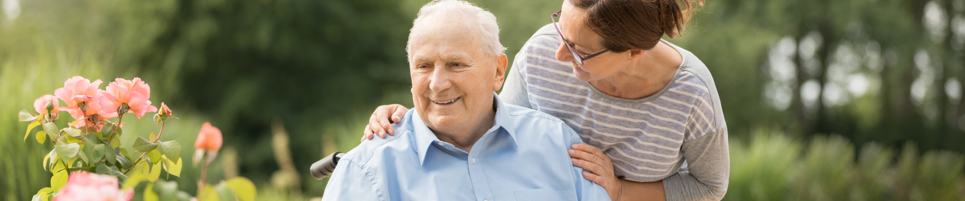 Caregiver helping senior man in wheelchair